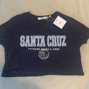 New Blue cropped Santa Cruz tee from Adika, new with tags, perfect condition, M